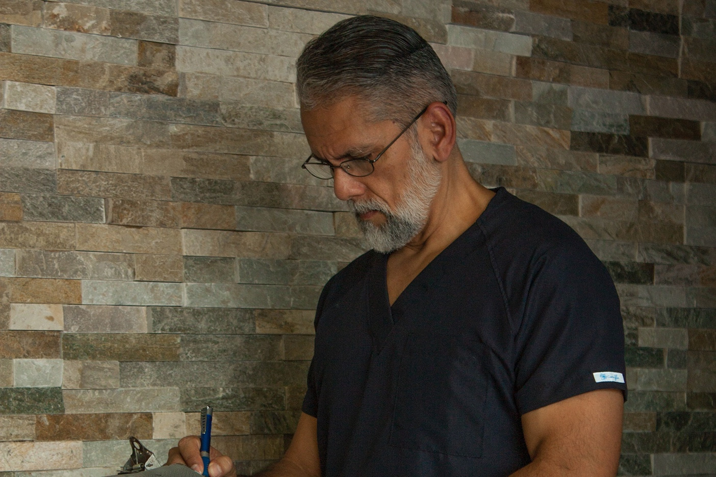 Nurse writing on a clipboard